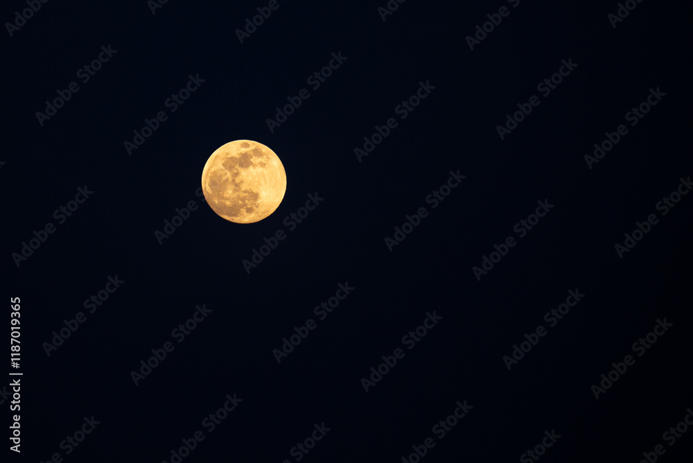 Full moon in the black sky. Close-up of the moon in the evening or night sky. Supermoon is an astronomical event. Full moon in the black sky. Close-up of the moon in the evening or night sky. Supermoon is an astronomical event.