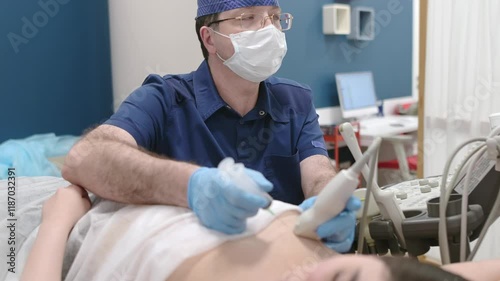 Mammalogist doctor examines a woman breasts and lymph nodes during appointment. Skillful oncologist puncture of mammary glands of young patient under review ultrasound for diagnosis of breast cancer.