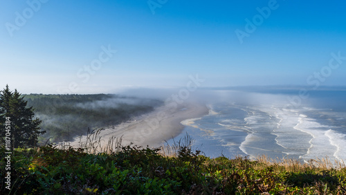 Waves roll ashore near Cape Disappointment State Park on a cloudy morning, Washington, USA. photo