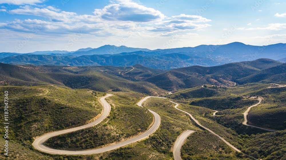 Aerial view of scenic mountain roads winding through lush landscape ideal for automotive themes with ample copyspace for text inclusion Aerial view of scenic mountain roads winding through lush landscape ideal for automotive themes with ample copyspace for text inclusion