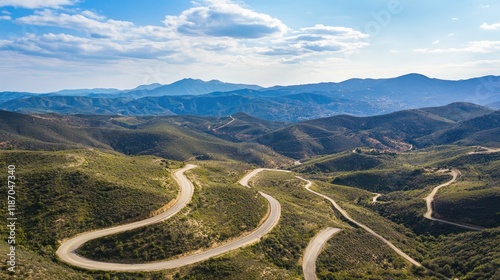 Aerial view of scenic mountain roads winding through lush landscape ideal for automotive themes with ample copyspace for text inclusion photo