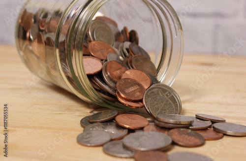 Glass Jar of American Coins on Wooden Table