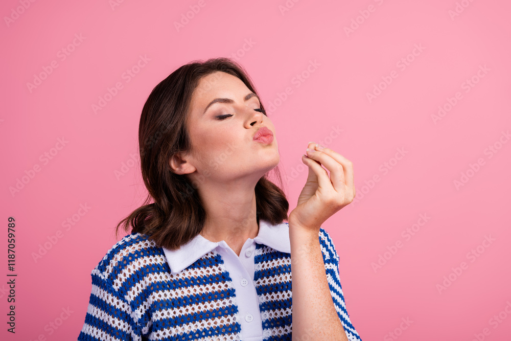 Young woman in stylish knit top makes fun expression against pink background Young woman in stylish knit top makes fun expression against pink background