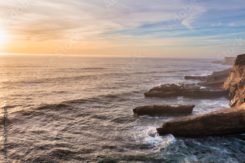 Aerial view of beautiful sandy beach and cliffs of Pacific Ocean coast on Highway 1 in California, Davenport, Santa Cruz. Travel concept, tourism, recreation, vacation
