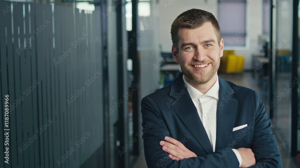 Confident young businessman standing in a modern office corridor, looking professional and composed. Concept of leadership, success, and corporate professionalism Confident young businessman standing in a modern office corridor, looking professional and composed. Concept of leadership, success, and corporate professionalism