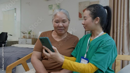 Wallpaper Mural Positive young caregiver explaining Asian senior woman how to use her new smartphone while providing home care service Torontodigital.ca