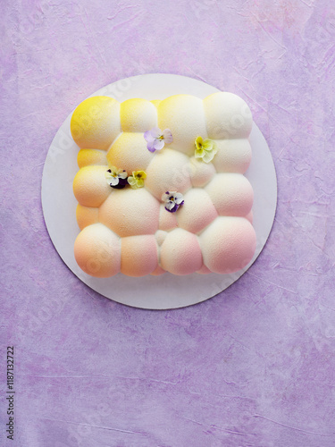 Modern Dessert Featuring Delicate Pastel Colors With Floral Accents on a Round Plate photo