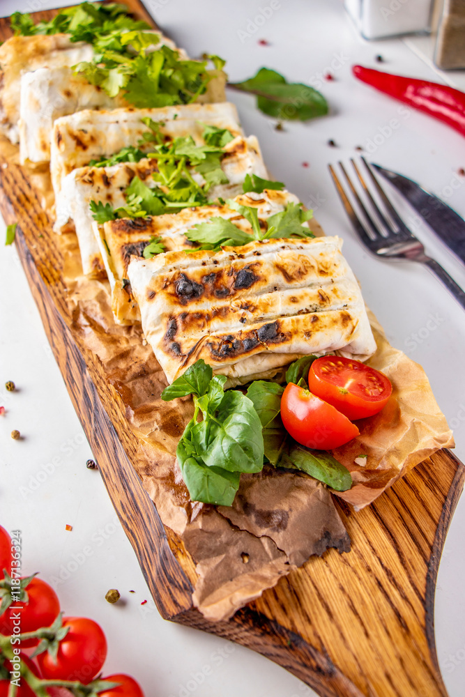 Lavash with chicken, baked on grill, served on wooden board Lavash with chicken, baked on grill, served on wooden board