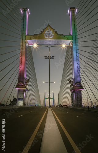 Obraz na płótnie Stunning scenery of Thotsamarachan Bridge or King Rama X Bridge crossing Chao phraya river with evening sky in the background. use it as your Wallpaper, Poster and Space for text, Selective focus. w salonie