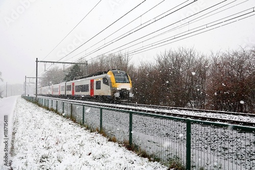 Passenger train in heavy snowfall.