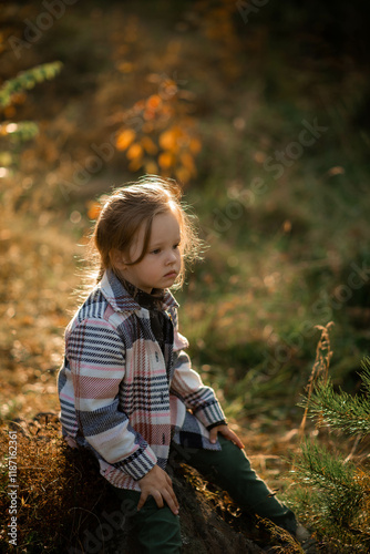 girl sitting on a stone in the forest