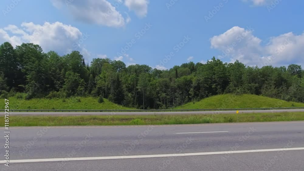 Point of view, left side car view. Driver window side driving view, POV driving on Highway 11 during travel. Roads of Canada with walls of green trees rural countryside wilderness car movie backing Point of view, left side car view. Driver window side driving view, POV driving on Highway 11 during travel. Roads of Canada with walls of green trees rural countryside wilderness car movie backing