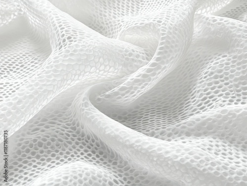 Delicate white mesh fabric displaying intricate patterns under soft lighting photo