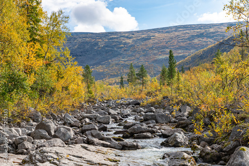 Obraz na płótnie View to Mannepakhp river at Khibiny mountains. Early autumn in arctic tundra region. Kola peninsula, Murmansk region, Russia. w salonie