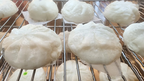 Steamed buns in a glass cabinet, Salapao street food Chinese cultural photo