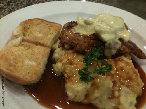 chop Chicken Steak toped by Cheese with garlic brade and mashed potatoes photo