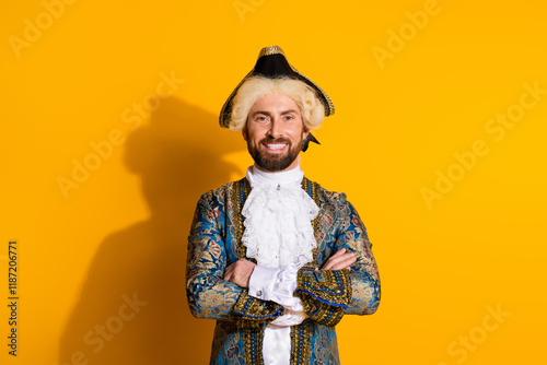 Portrait of a charismatic young man in a classic aristocratic costume against a bright yellow background photo