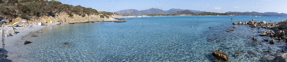 Fototapeta premium Extra wide view of The beautiful Cala Porto Giunco ​​with crystal clear, blue and turquoise water