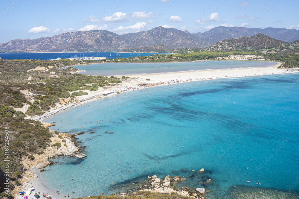 VIllasimius, Italy - 09-05-2024: Aerial view of the beautiful beach of Porto Giunco in Villasimius with white sand and crystal clear water with the Notteri pond in the background