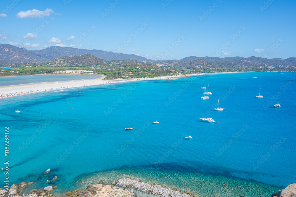 VIllasimius, Italy - 09-05-2024: Aerial view of the beautiful beach of Porto Giunco in Villasimius with white sand and crystal clear water with the Notteri pond in the background