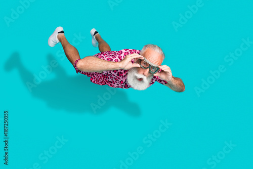Full length photo of handsome bearded grandpa amazed falling parachutist wear pink leopard print garment isolated on cyan color background