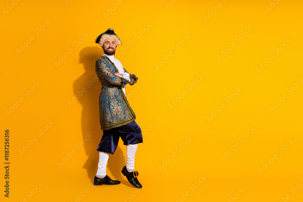 Young man dressed as a historic aristocrat in elegant attire against vibrant yellow background Young man dressed as a historic aristocrat in elegant attire against vibrant yellow background