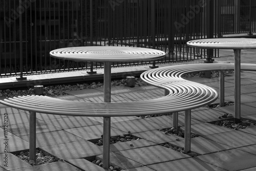 Modern metal tables and benches, outdoor seating.