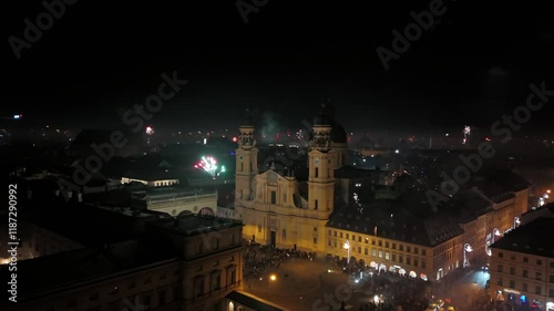 Aerial shot at midnight of fireworks and firecrackers lighting up downtown Munich, Germany, Odeonplatz. Feldherrnhalle and Theatinerkirche stand as part of festive scene. Silvester Feuerwerk Muenchen photo