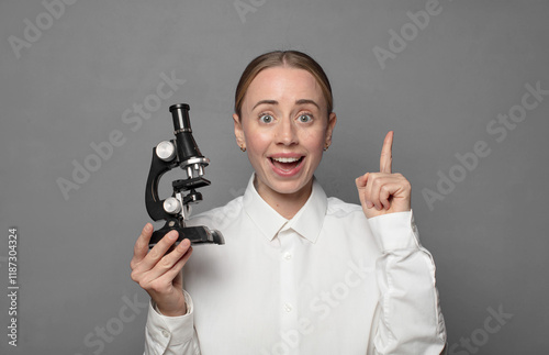 young pretty scient student with a microscope photo