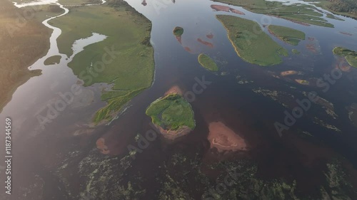 Aerial footage of the Angesan forest river at sunset in Overkalix Municipality in Norrbotten, Sweden photo