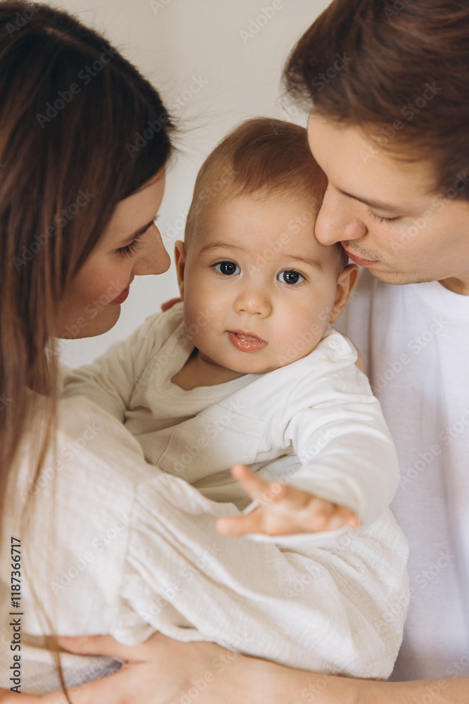 Young family embracing their baby with love and tenderness Young family embracing their baby with love and tenderness