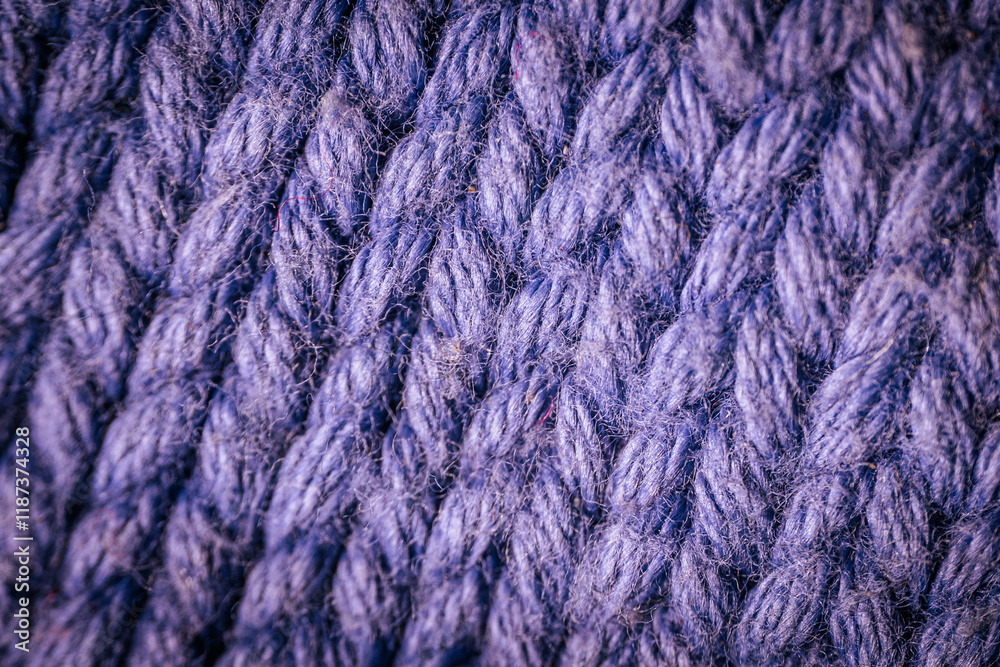 A macro view of dark blue knitted fabric showcasing the rich texture and thick yarn weave. The soft and intricate fibers highlight the cozy and durable material. A macro view of dark blue knitted fabric showcasing the rich texture and thick yarn weave. The soft and intricate fibers highlight the cozy and durable material.