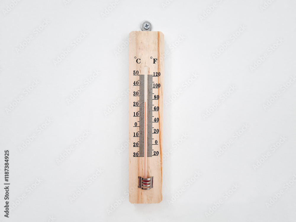Wooden thermometer on white wall background. Wooden thermometer with dual Celsius and Fahrenheit scales hanging on a white concrete wall. Wooden thermometer on white wall background. Wooden thermometer with dual Celsius and Fahrenheit scales hanging on a white concrete wall.