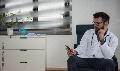 Close up portrait of handsome Caucasian senior joyful male doctor infectionist in white coat sitting in cabinet in clinic at work talking on video call online through webcam with patient medic concept photo