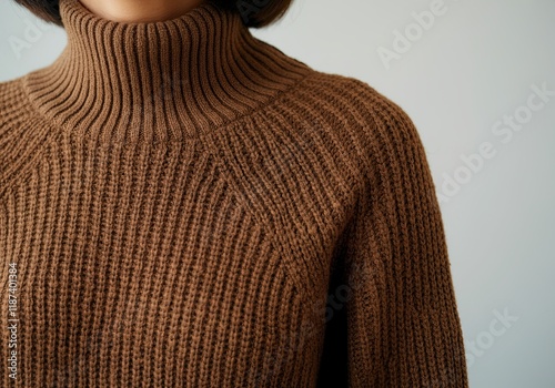 Close-up of a woman wearing a stylish brown mocha turtleneck sweater, showcasing cozy autumn fashion