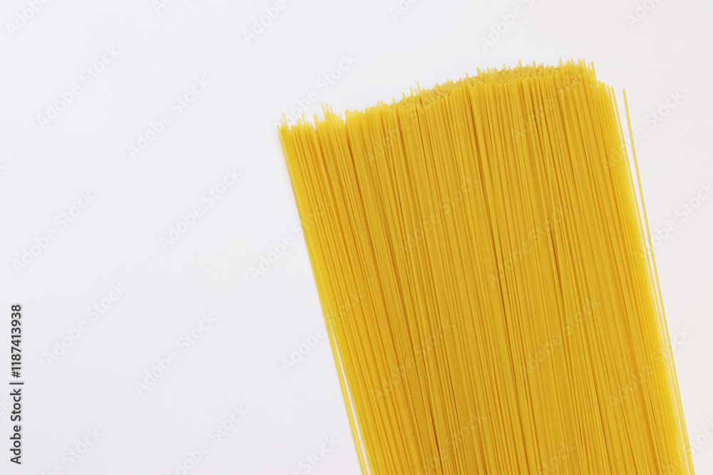 Raw dry spaghetti on light background. Spaghetti from durum wheat. Dry spaghetti, top view, copy space. Uncooked yellow pasta. Heap of spaghetti, raw Italian pasta on white background Raw dry spaghetti on light background. Spaghetti from durum wheat. Dry spaghetti, top view, copy space. Uncooked yellow pasta. Heap of spaghetti, raw Italian pasta on white background