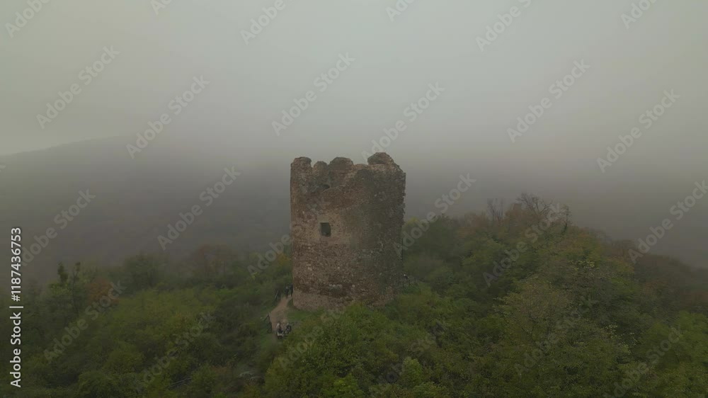 Medieval tower emerges from fog - drone aerial view, Vrdnik, Fruska gora, Novi Sad, Serbia Medieval tower emerges from fog - drone aerial view, Vrdnik, Fruska gora, Novi Sad, Serbia