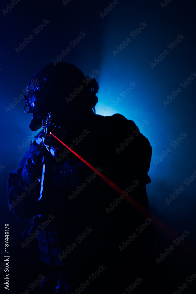 Fototapeta premium Silhouette of a Tactical Soldier with Red Laser Backlit in Fog