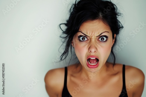 A woman makes a comical face with her eyes wide open, a playful and humorous moment