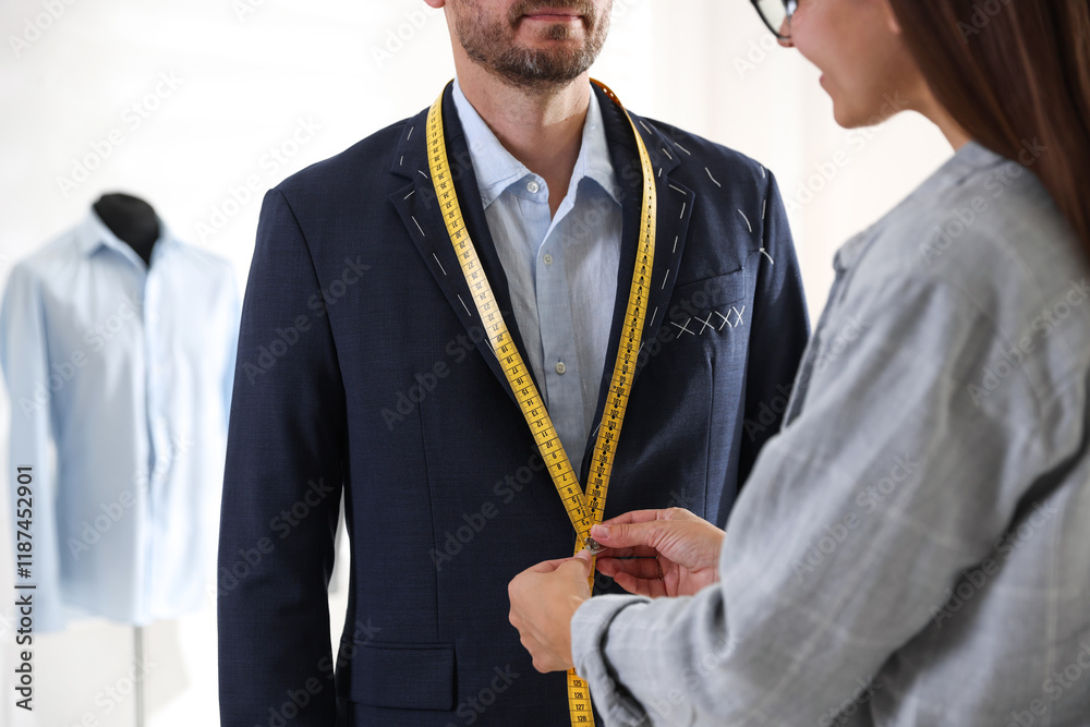 © New Africa - Tailor measuring jacket on man during fitting in atelier, closeup © New Africa - Tailor measuring jacket on man during fitting in atelier, closeup