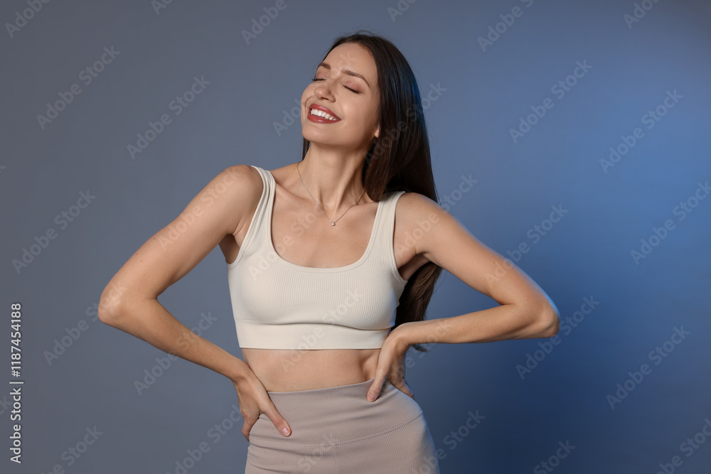 Beautiful woman in stylish sportswear on grey background Beautiful woman in stylish sportswear on grey background