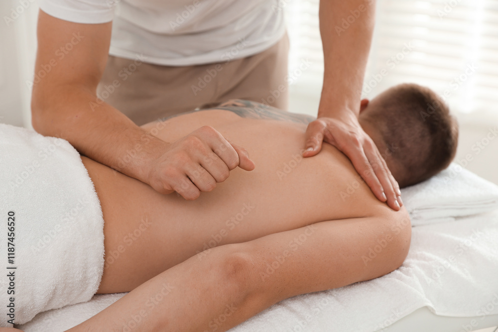 Massage therapist working with patient in clinic, closeup Massage therapist working with patient in clinic, closeup