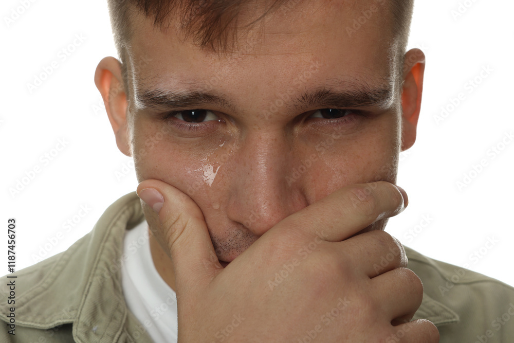 Fototapeta premium Distressed young man crying on white background