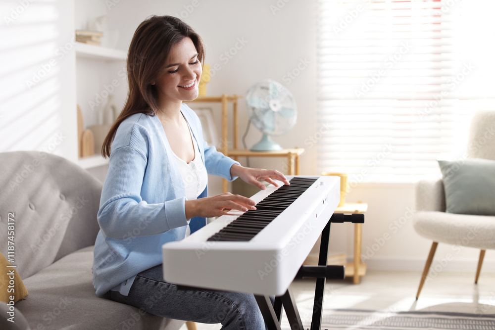 Smiling woman playing synthesizer at home, space for text Smiling woman playing synthesizer at home, space for text