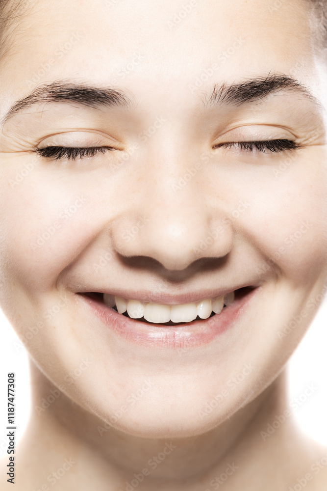 Obraz premium Close-up portrait of a joyful young woman smiling, showcasing natural beauty