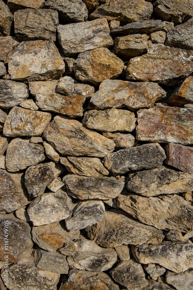 Stones texture of a medieval castle wall. Dry stone pattern of an ancient building made of rocks Stones texture of a medieval castle wall. Dry stone pattern of an ancient building made of rocks
