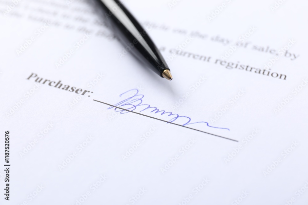 Signature and pen on paperwork, closeup view Signature and pen on paperwork, closeup view