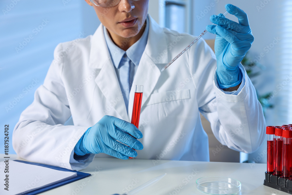 Laboratory testing. Doctor with blood sample and pipette indoors, closeup Laboratory testing. Doctor with blood sample and pipette indoors, closeup