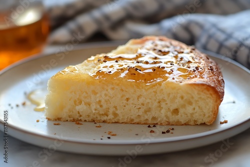 Ethiopian Ambasha Bread Slice with Honey Glaze on Plain Plate photo