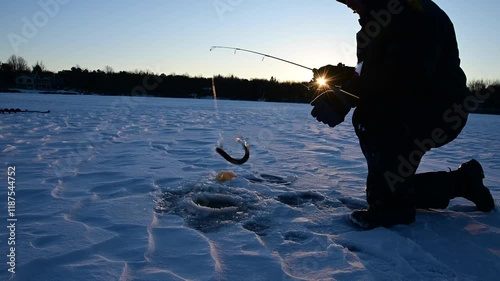 3ice fisherman catching fish, selective focus man in silhouette